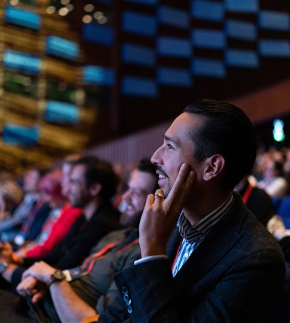 Image of conference participants looking at stage.