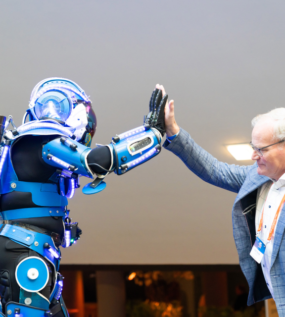 robot and man in suit doing a high five