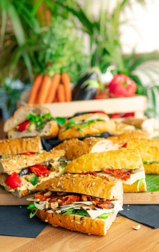 A selection of sandwiches filled with vegetables and herbs.