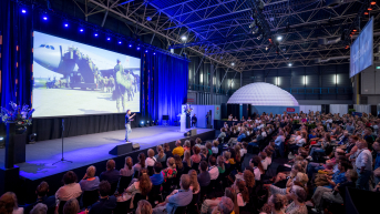 Image of conference plenary room with screen.