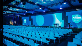Image of conference plenary room with screen.