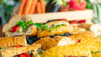 A selection of sandwiches filled with vegetables and herbs.