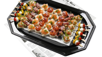 A platter featuring assorted appetizers like canapés and skewers.