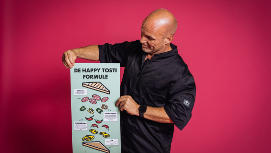 Man holding a poster of the happy toast formula.