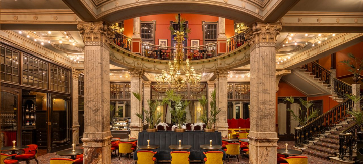 Stylish hotel interior with marble columns and chandeliers.