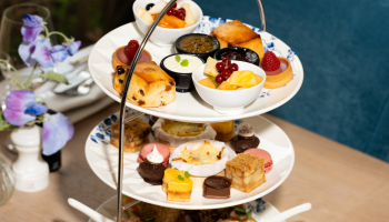 Three tiers of scones, pastries, and fruit on a stand