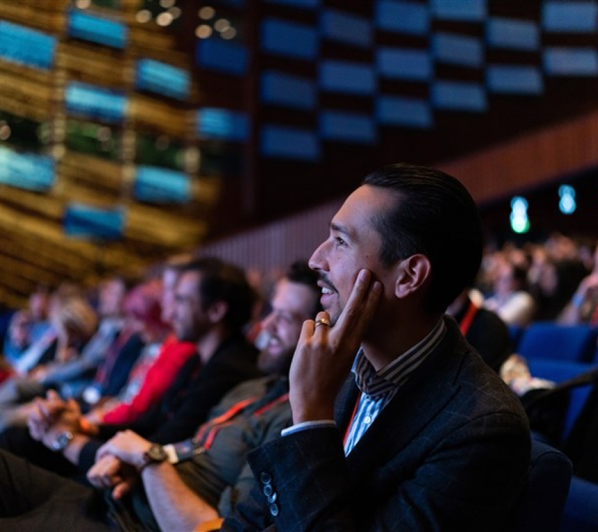 Image of conference participants looking at stage.