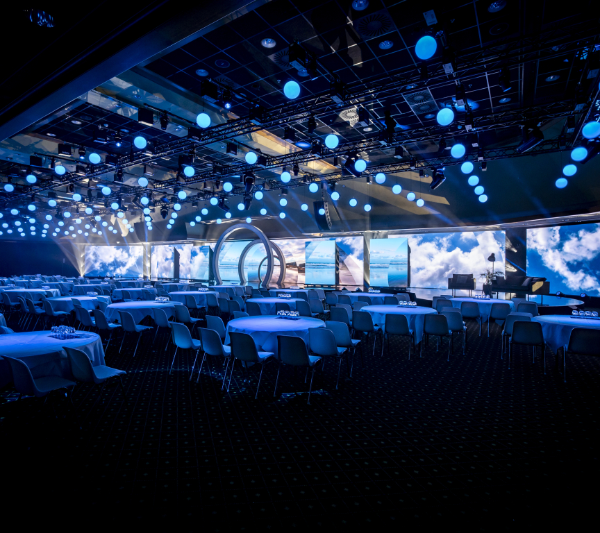 Image of conference plenary room with screen.