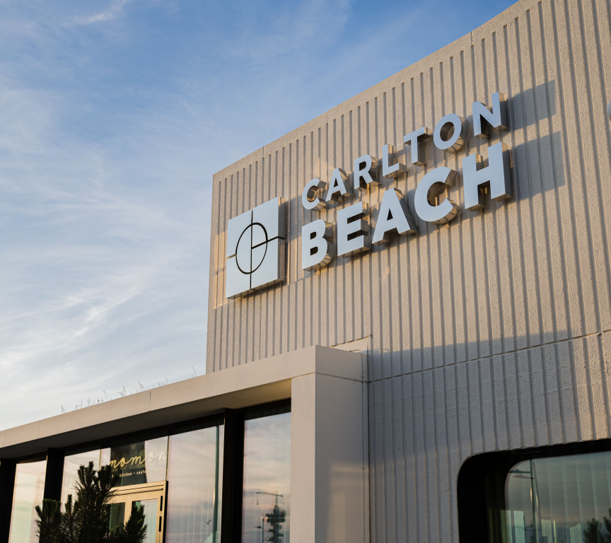 View of Carlton Beach Hotel against a blue sky