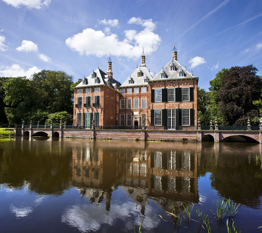 A historic building reflected in the water.