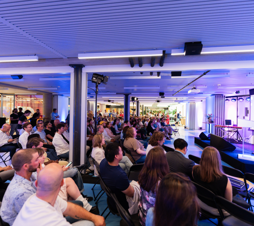 A speaker stands in front of an audience during the Hague Tech Awards.