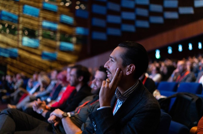 Image of conference participants looking at stage.