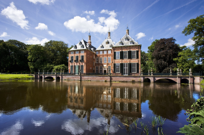 A historic building reflected in the water.
