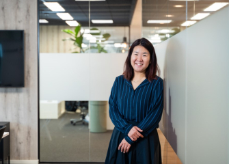 Woman with long, wavy hair standing in an office