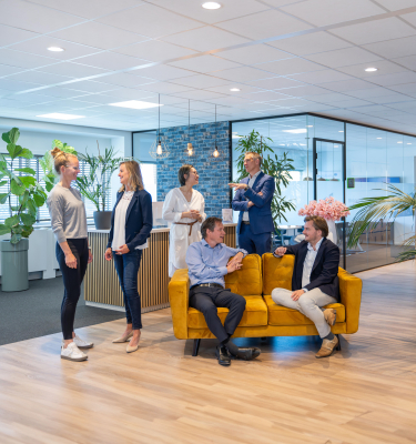 Group of people in a modern office space with plants