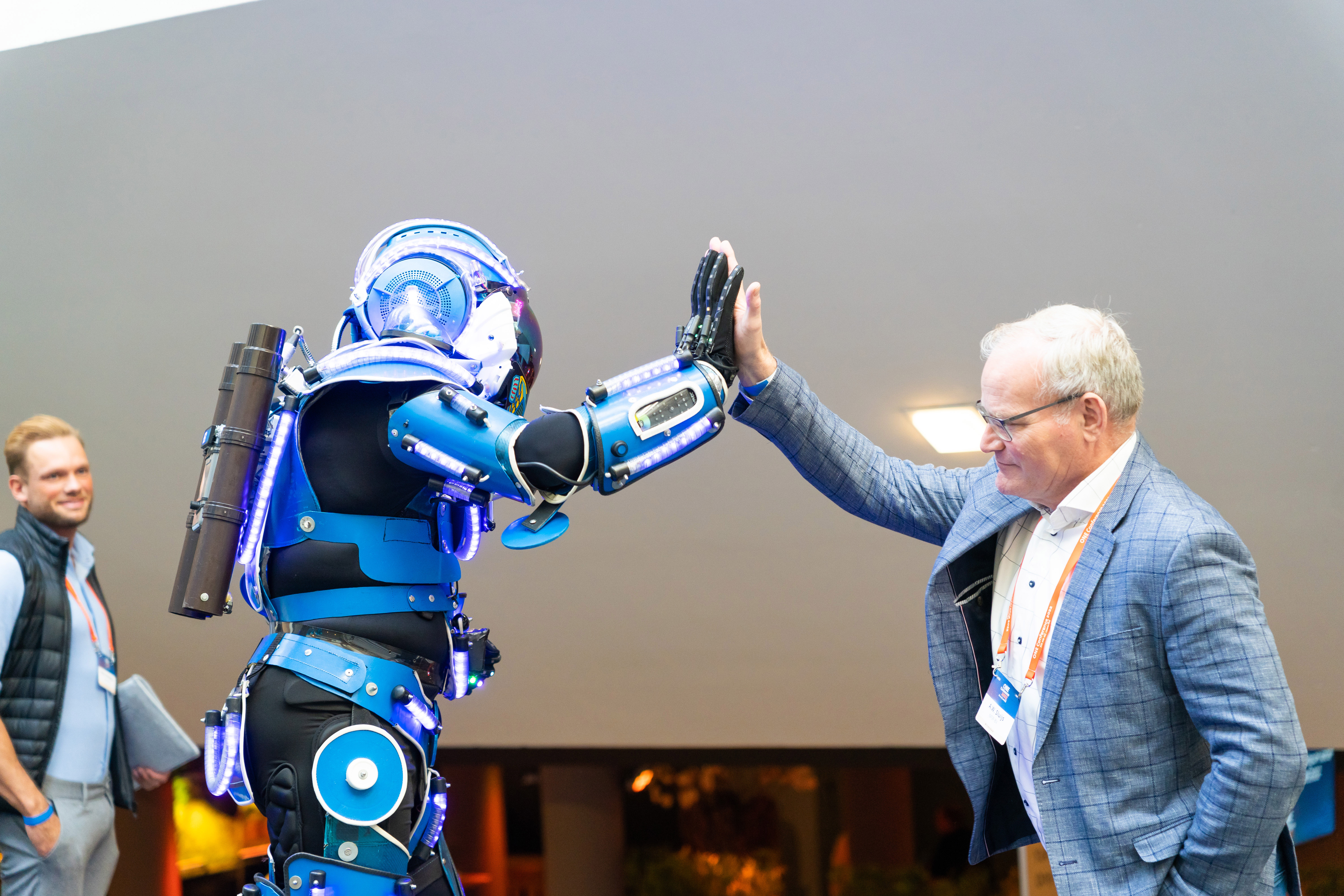 robot and man in suit doing a high five