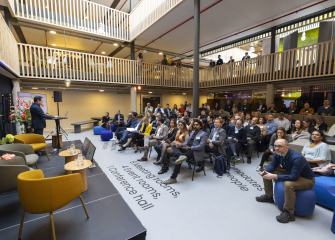 People listening to a presentation at Titaan