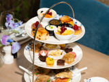 Three tiers of scones, pastries, and fruit on a stand
