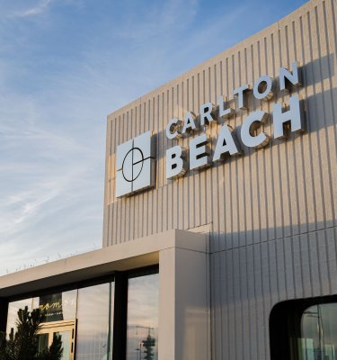 View of Carlton Beach Hotel against a blue sky