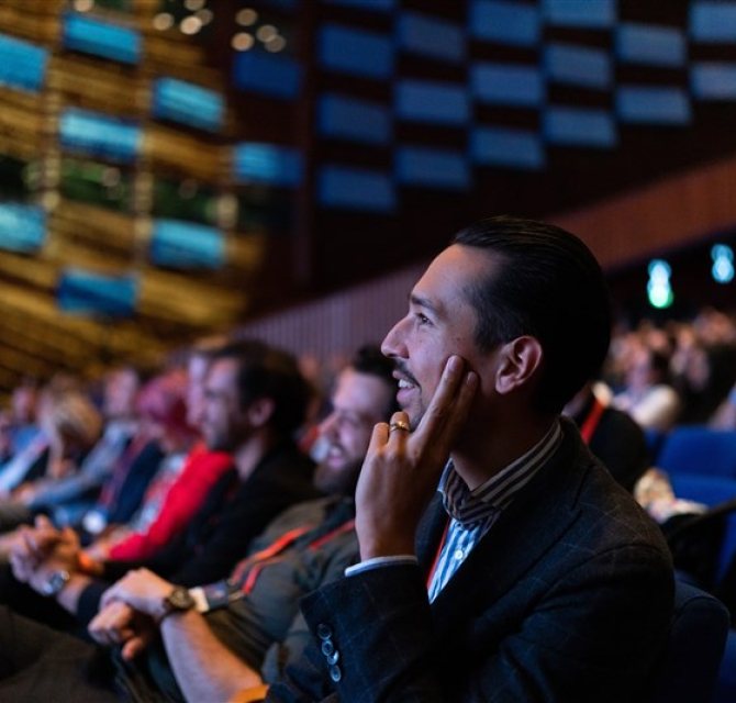 Image of conference participants looking at stage.
