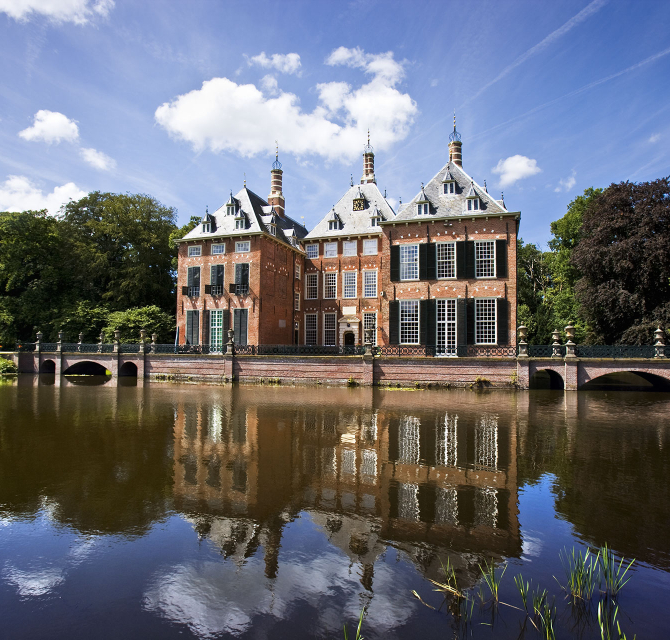 A historic building reflected in the water.