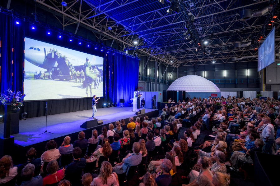 Image of conference plenary room with screen.