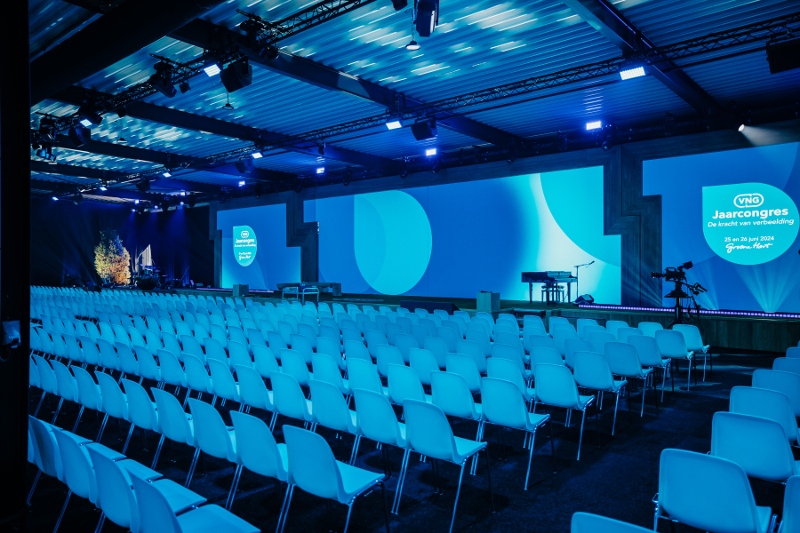 Image of conference plenary room with screen.