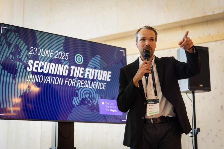 A man with a microphone is presenting about innovation.