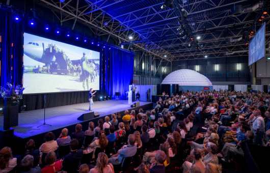 Image of conference plenary room with screen.