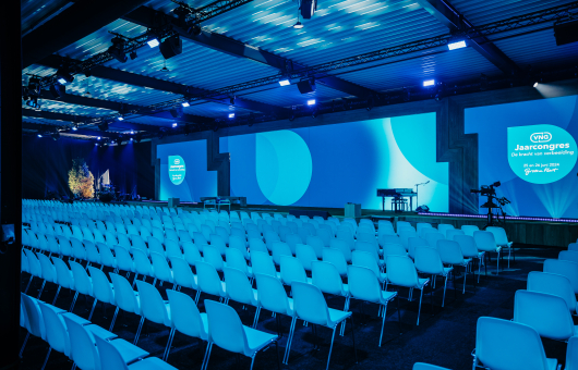 Image of conference plenary room with screen.