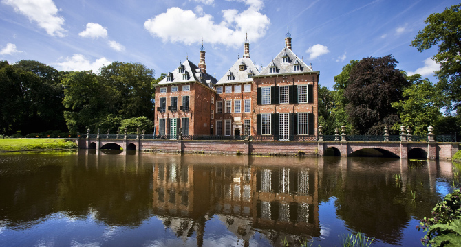 A historic building reflected in the water.