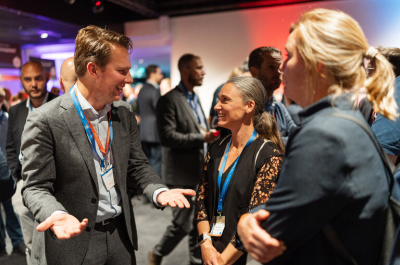 People talking and networking at an event in The Hague.
