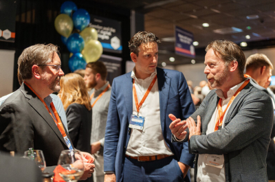 Three men chatting at a networking event.