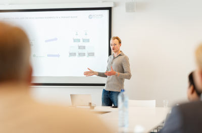 A man is giving a presentation in a meeting room.