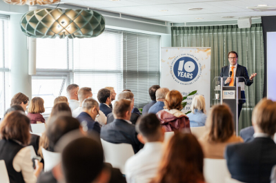 A speaker presenting at a 10-year anniversary event.
