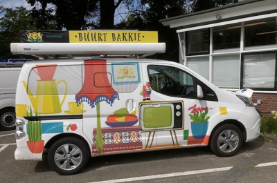 A painted food truck with colorful designs and the text 'Buurt Bakkie' on it.