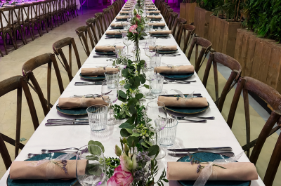Long table with decorative elements and napkins