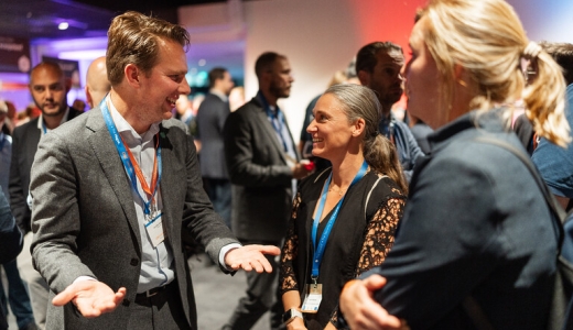 People talking and networking at an event in The Hague.