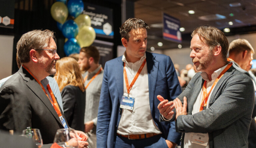 Three men chatting at a networking event.