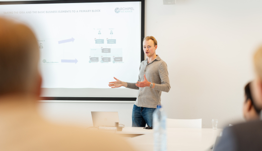 A man is giving a presentation in a meeting room.