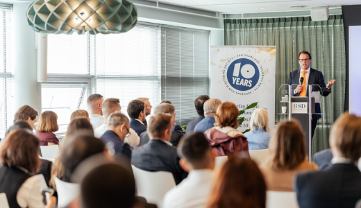 A speaker presenting at a 10-year anniversary event.