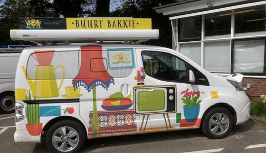 A painted food truck with colorful designs and the text 'Buurt Bakkie' on it.