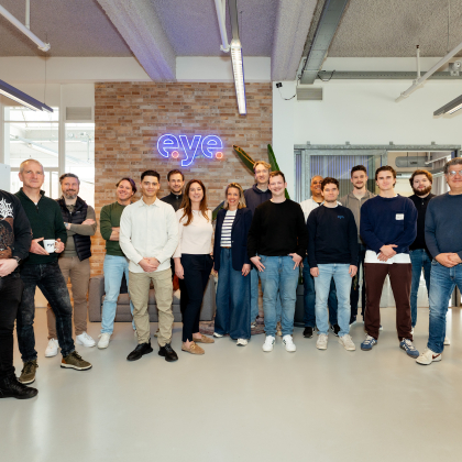 Een diverse groep mensen staat samen in een kantoor.