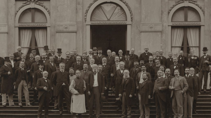 Historical photo of a group of men on the steps of a building.
