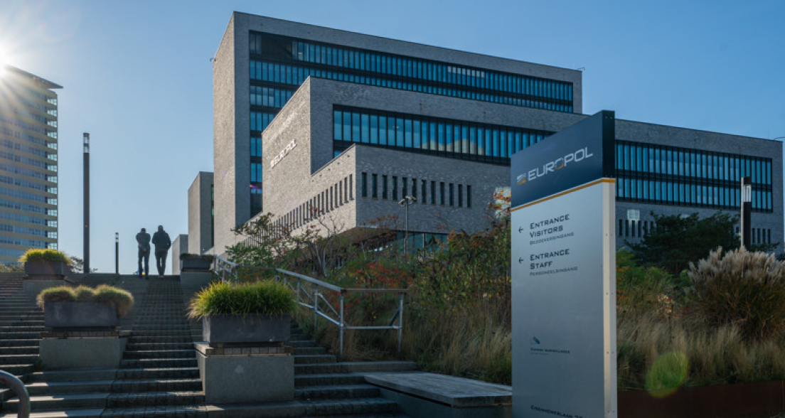 Two people walking up the steps at the Europol office