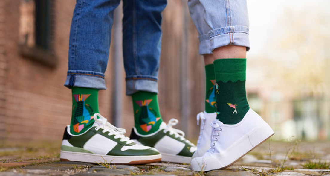 Two people in sneakers with colorful socks on the street