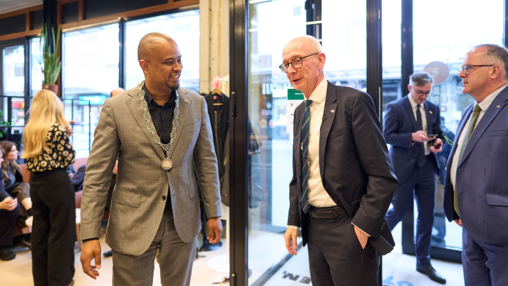 Two men talking in a modern space.