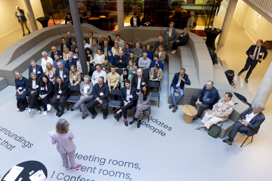 A gathering with speakers and an engaged audience.