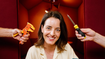 A woman poses with various tools in her hands.