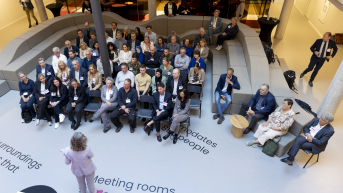 A gathering with speakers and an engaged audience.